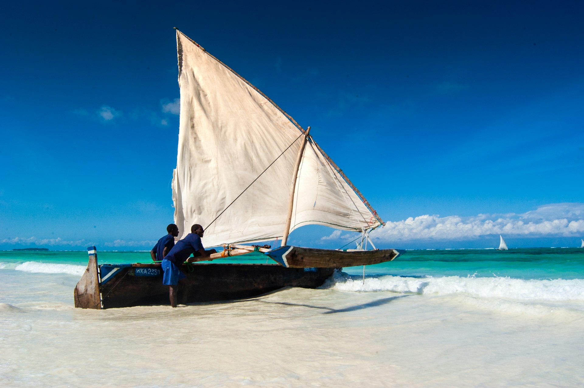 A traditional dhow on the turquoise water off Matemwe, with the reef on the horizon